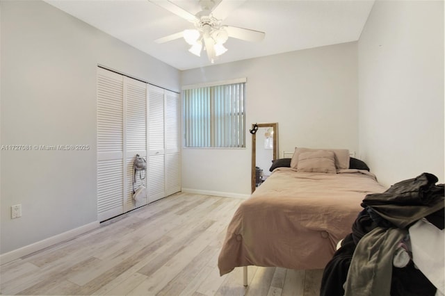 bedroom featuring ceiling fan, a closet, and light wood-type flooring