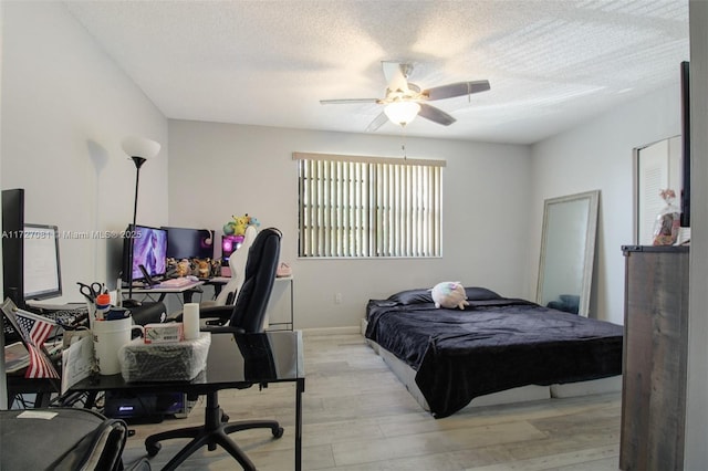 bedroom featuring ceiling fan, a textured ceiling, and light hardwood / wood-style flooring