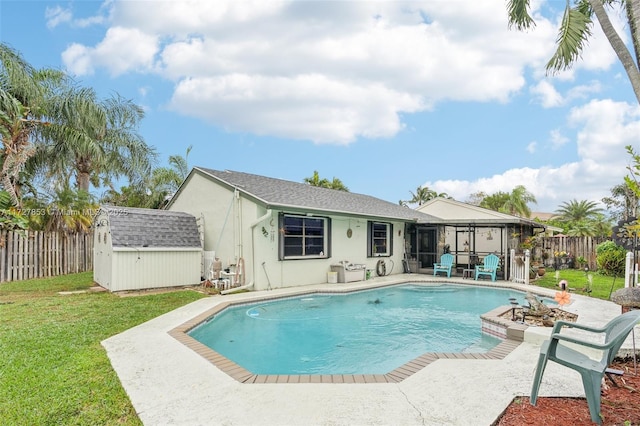 view of pool featuring a storage shed, a yard, and a patio