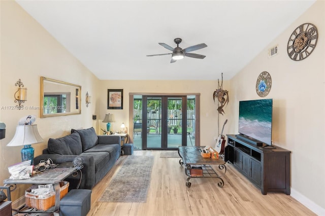 living room featuring ceiling fan, french doors, and light hardwood / wood-style floors