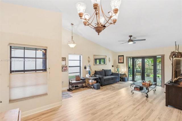 living room featuring ceiling fan, french doors, light hardwood / wood-style floors, and lofted ceiling