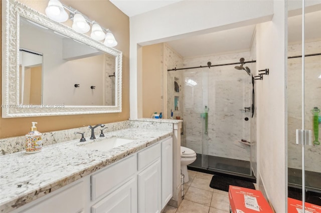 bathroom featuring toilet, an enclosed shower, tile patterned floors, and vanity