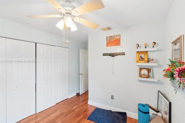 bedroom with a closet, ceiling fan, and light wood-type flooring