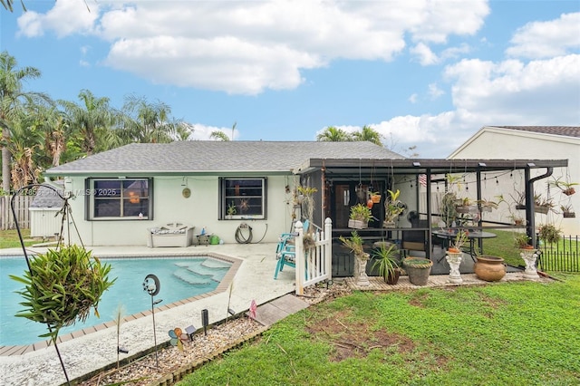 back of house featuring a fenced in pool, a patio, and a yard