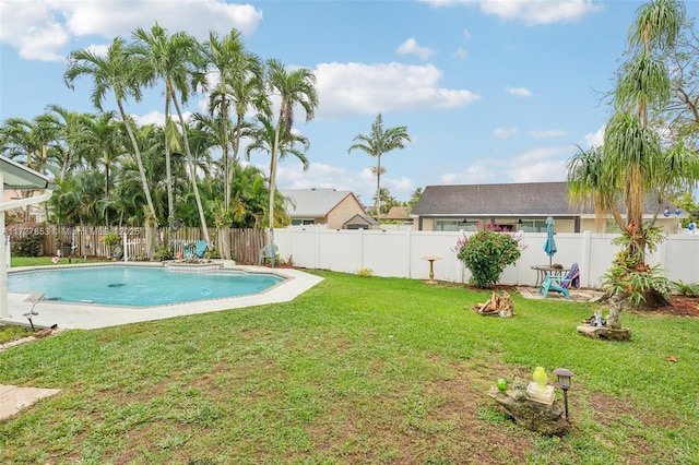 view of pool with a yard