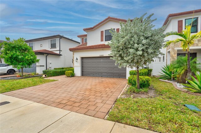 view of front of property with a garage and a front lawn