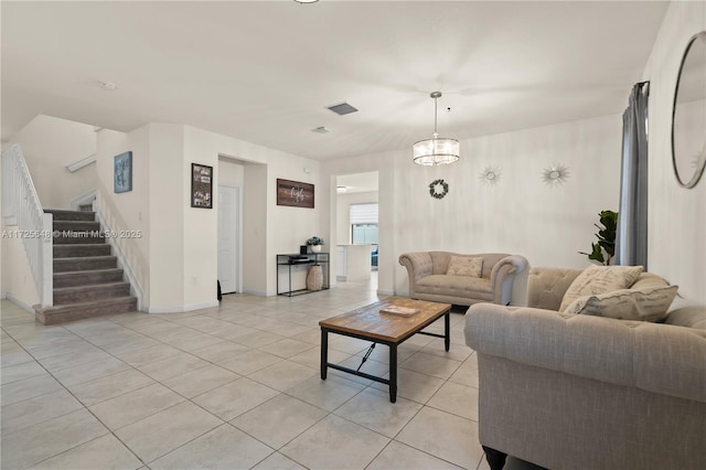 living room with a notable chandelier and light tile patterned floors