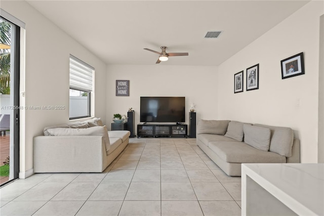 living room with ceiling fan and light tile patterned floors