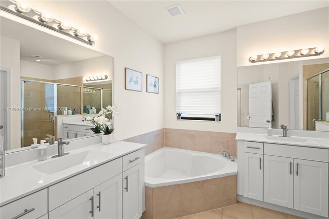 bathroom featuring plus walk in shower, tile patterned floors, and vanity