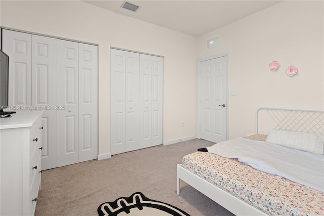 carpeted bedroom with two closets