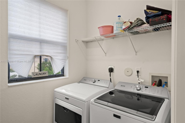 laundry room with washing machine and clothes dryer