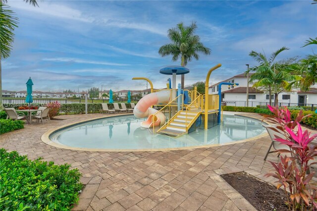 view of swimming pool with a playground