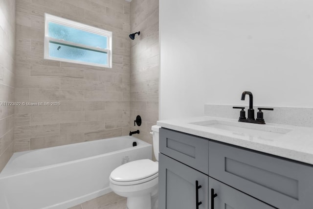 full bathroom featuring toilet, vanity, and tiled shower / bath