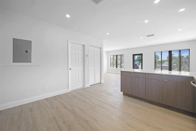 spare room with light wood-type flooring and electric panel