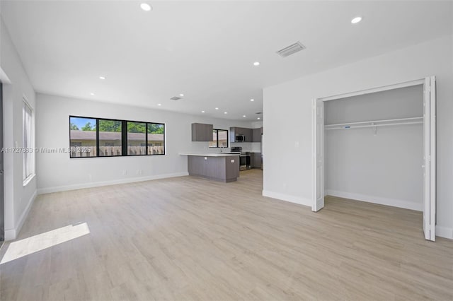 unfurnished living room featuring light hardwood / wood-style floors