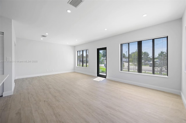 spare room with light hardwood / wood-style floors