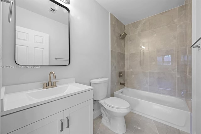 full bathroom with tile patterned floors, tiled shower / bath combo, vanity, and toilet