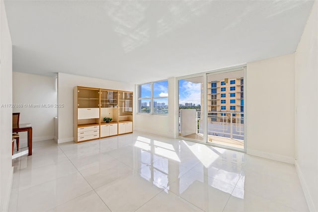 430 Golden Isles Dr Unit 707, Hallandale Beach, FL 33009 - spare room with baseboards and light tile patterned flooring