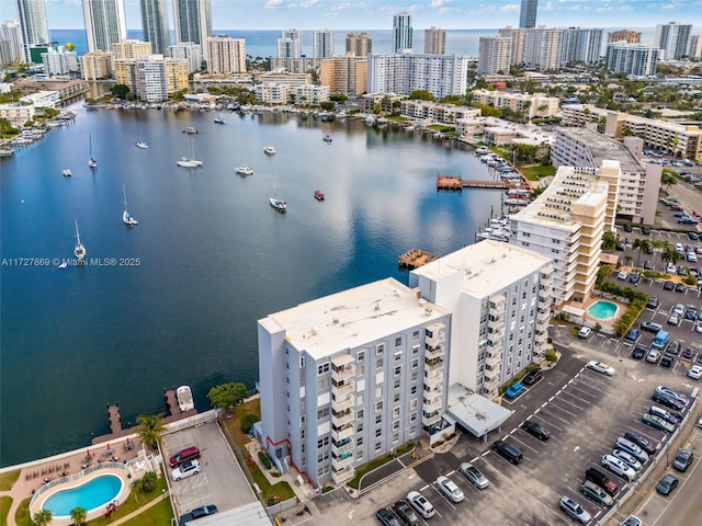430 Golden Isles Dr Unit 707, Hallandale Beach, FL 33009 - aerial view of city skyline, a nearby body of water, and a pool area