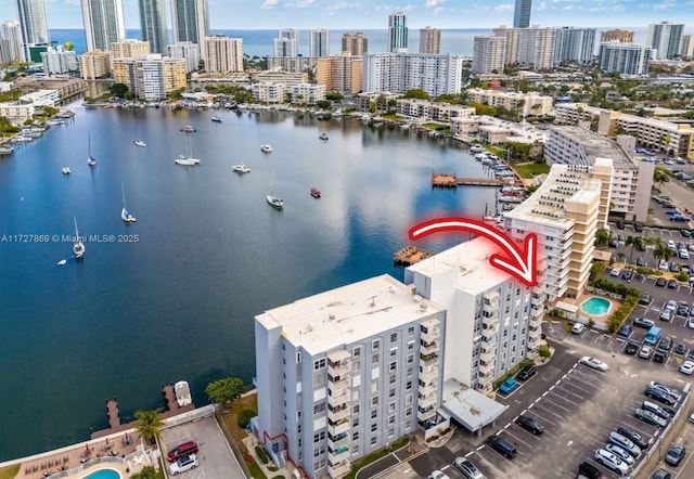 birds eye view of property with a view of city and a water view