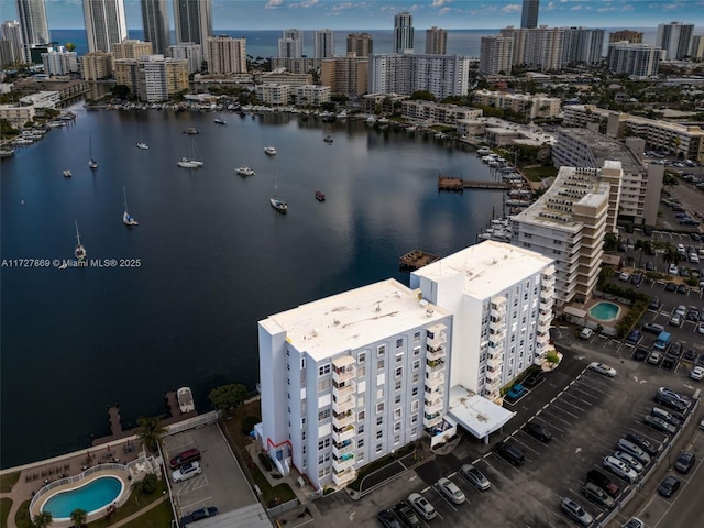 drone / aerial view featuring a water view and a view of city