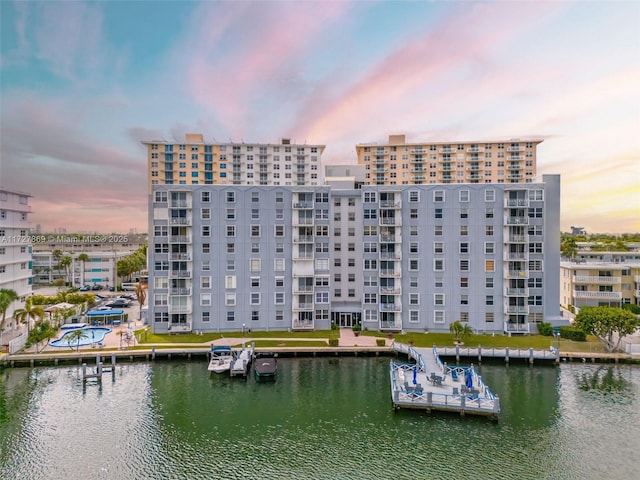 exterior space with a water view and a city view