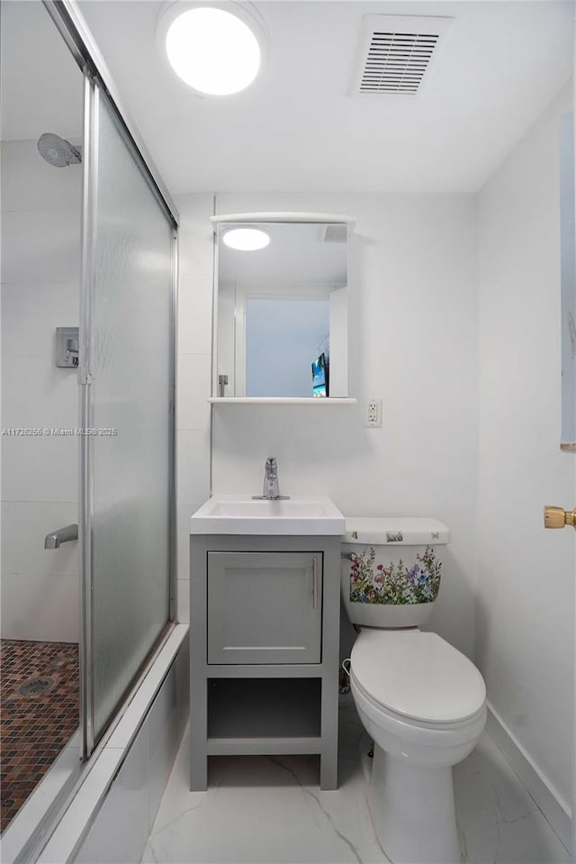 bathroom with toilet, a shower with door, and vanity