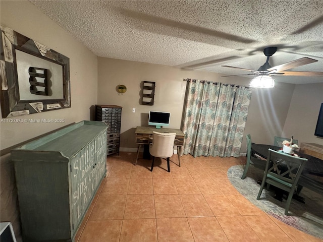 tiled office featuring ceiling fan and a textured ceiling