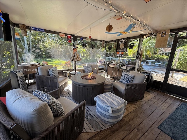 sunroom with a wealth of natural light and a jacuzzi