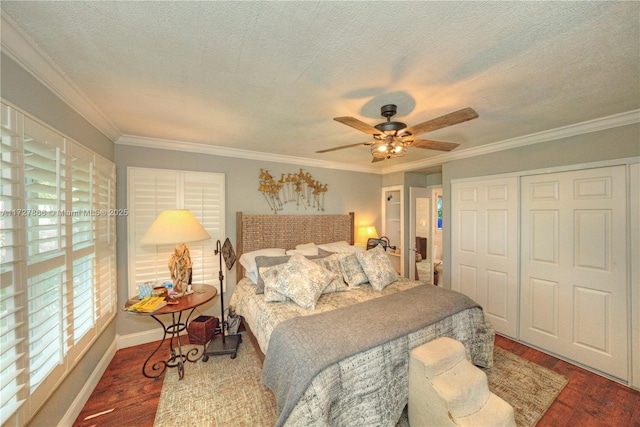 bedroom with ceiling fan, a closet, crown molding, and wood-type flooring