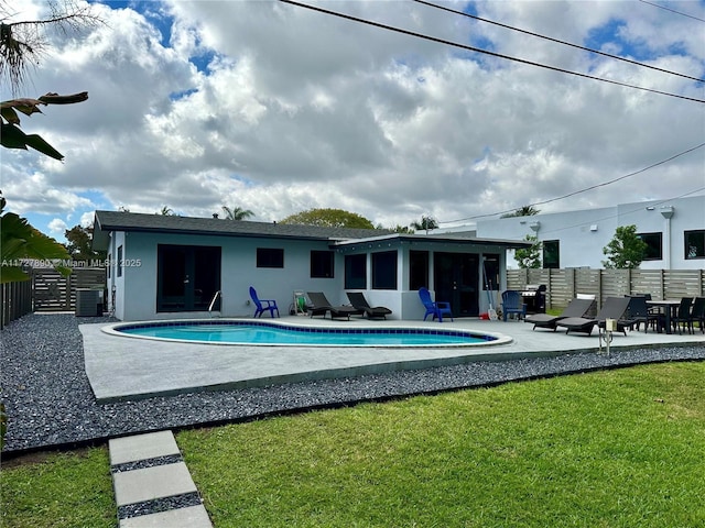 view of swimming pool featuring a yard and a patio