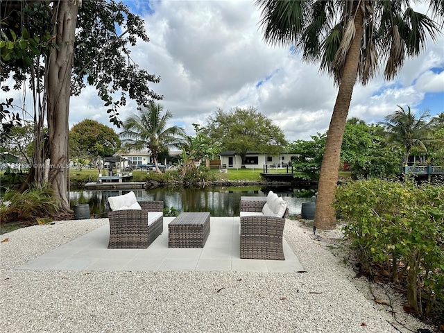 view of patio / terrace with a water view and outdoor lounge area