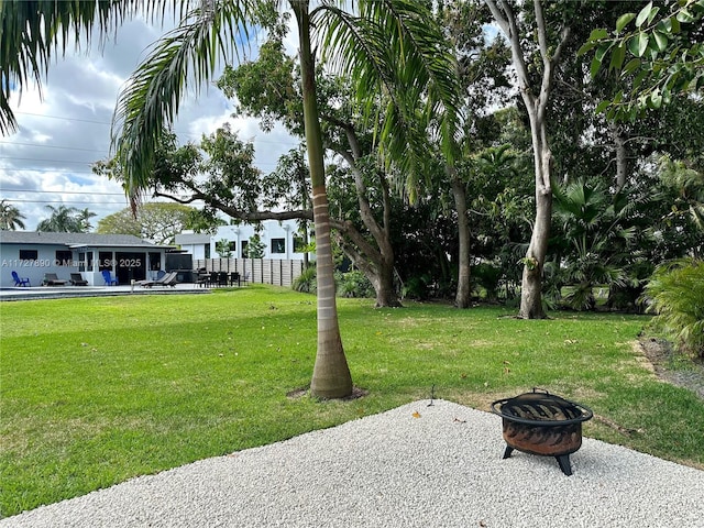 view of yard with a patio and a fire pit