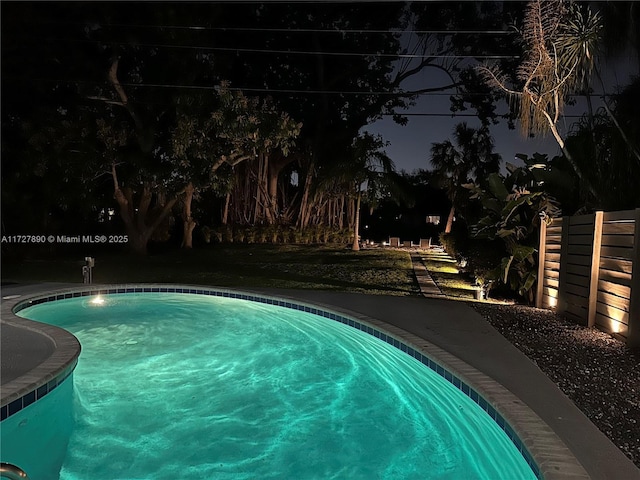 view of pool at night