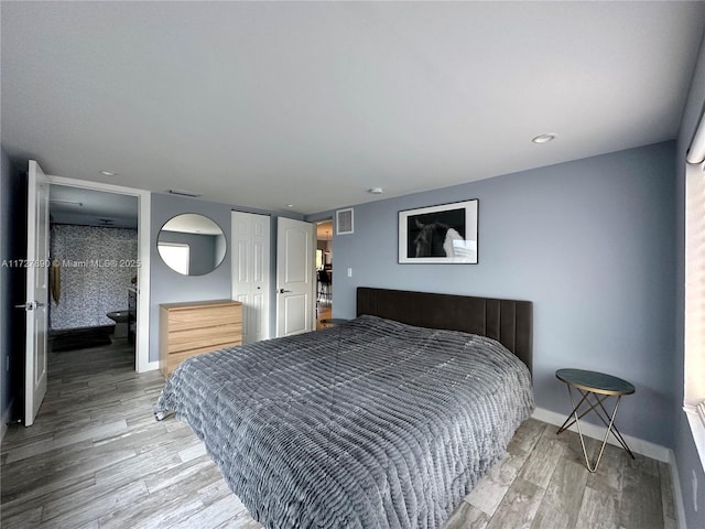 bedroom featuring hardwood / wood-style flooring and a closet