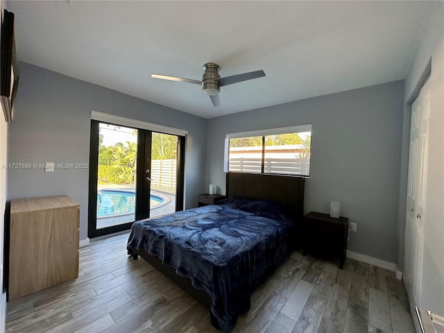 bedroom featuring hardwood / wood-style flooring, ceiling fan, and access to outside