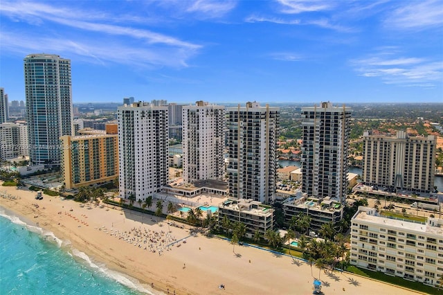 view of city featuring a beach view and a water view