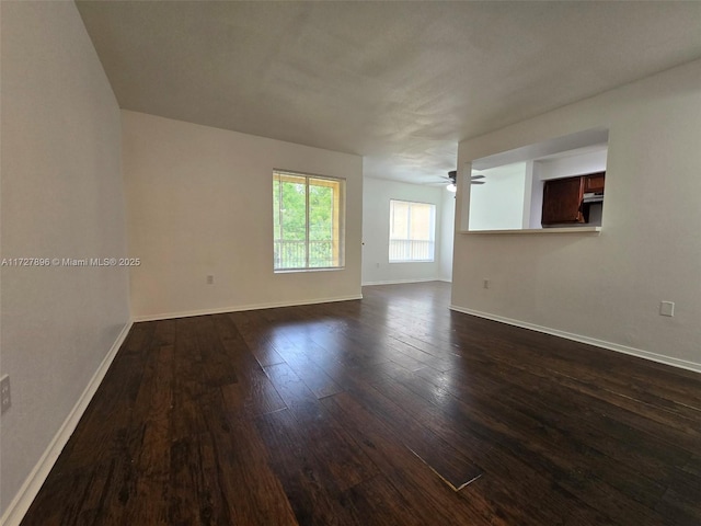 spare room with ceiling fan and dark hardwood / wood-style floors