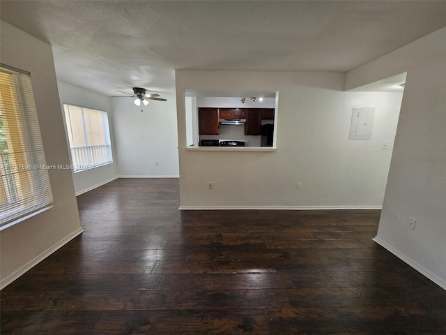 unfurnished living room with ceiling fan and dark hardwood / wood-style flooring