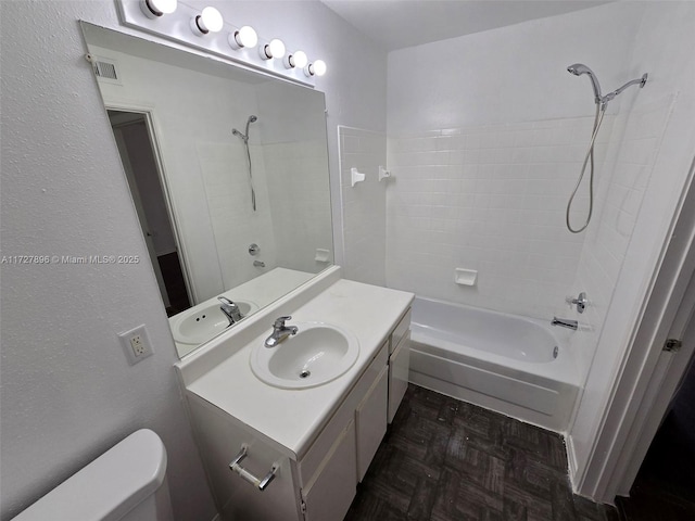 full bathroom with tub / shower combination, toilet, vanity, and parquet floors