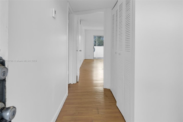 corridor with light hardwood / wood-style floors