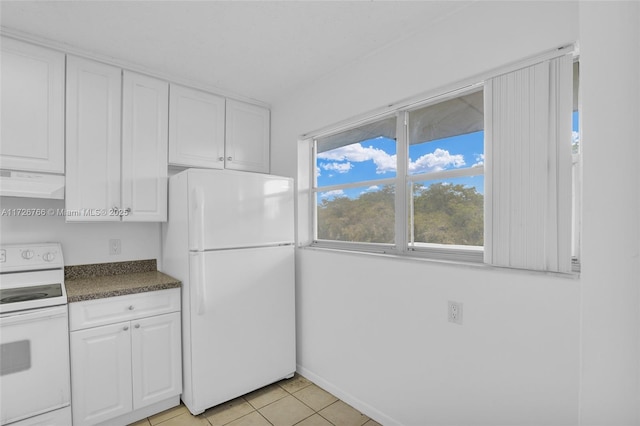 kitchen with light tile patterned floors, white appliances, and white cabinetry