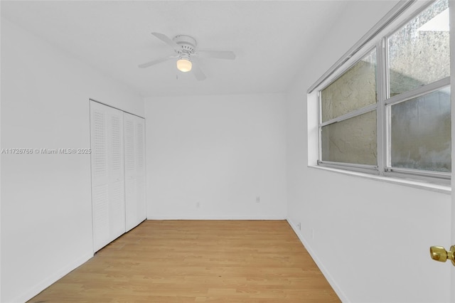 empty room with ceiling fan and light wood-type flooring