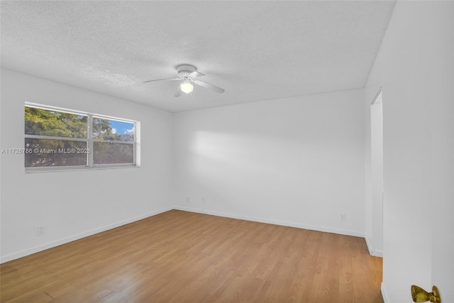 empty room featuring light wood-type flooring, ceiling fan, and a textured ceiling