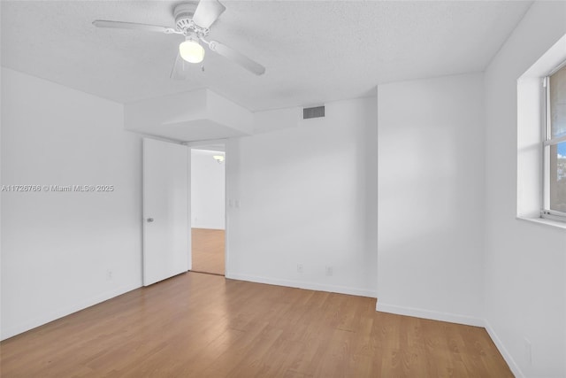 unfurnished room with a textured ceiling, ceiling fan, and light hardwood / wood-style floors