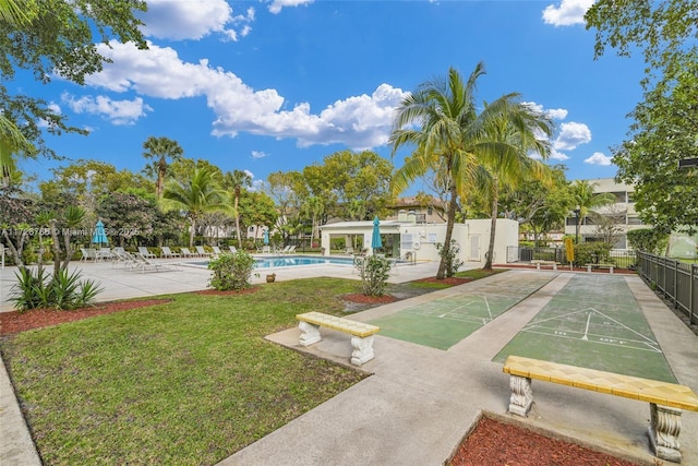 view of home's community featuring a swimming pool and a lawn