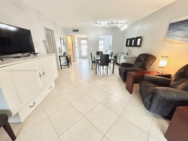 living room with light tile patterned floors and rail lighting