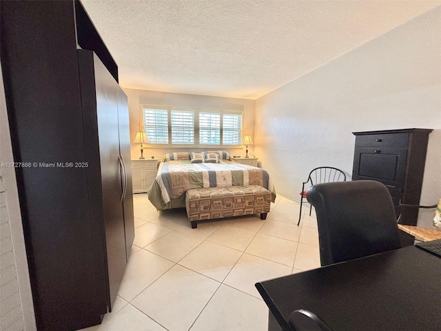 bedroom with light tile patterned flooring and a textured ceiling