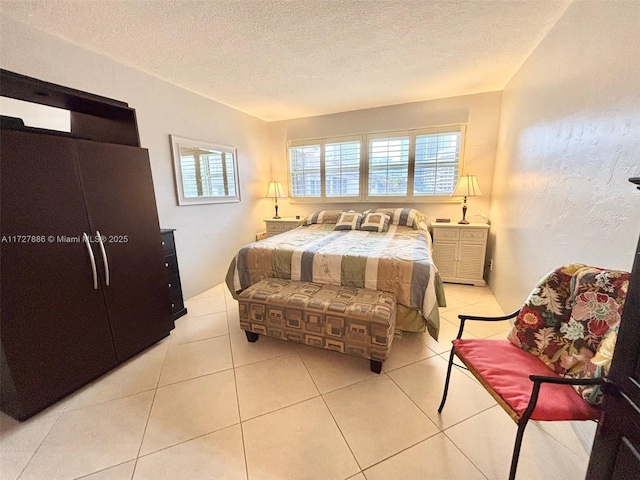 tiled bedroom featuring a textured ceiling