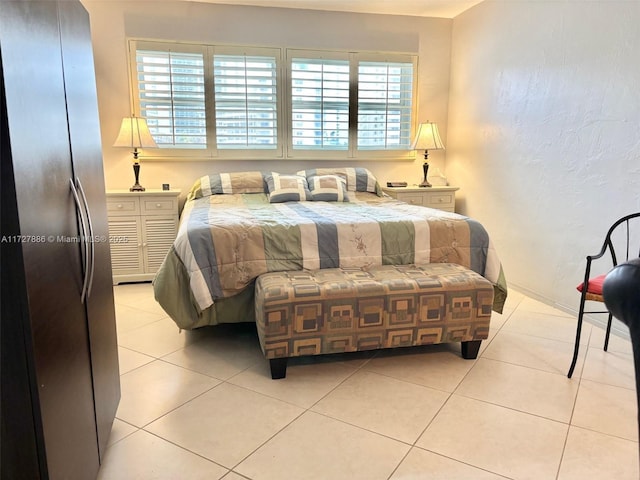 tiled bedroom featuring multiple windows